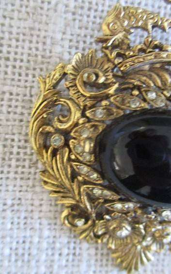 Pretty vintage gold tone brooch intricate filigree border