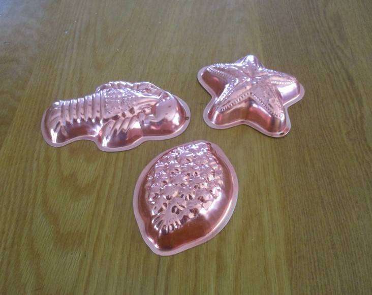 Three small copper jelly moulds