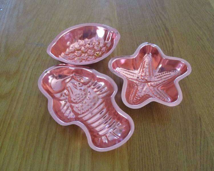Three small copper jelly moulds