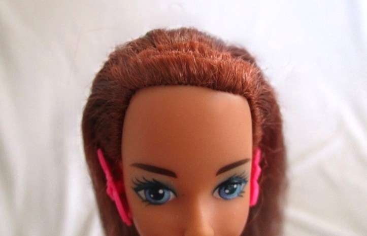A Mattel Barbie with gorgeous EXTRA long red hair with original earrings - knees bend