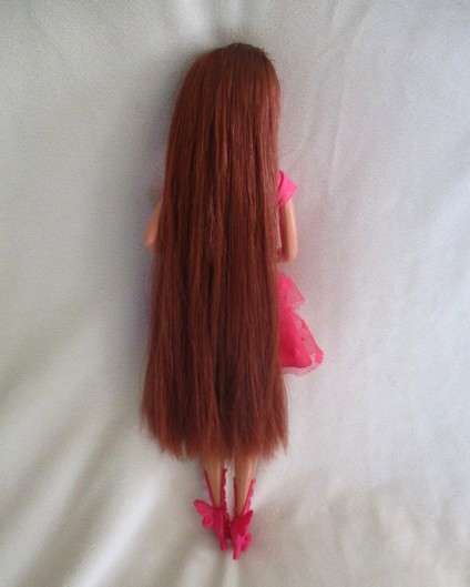 A Mattel Barbie with gorgeous EXTRA long red hair with original earrings - knees bend
