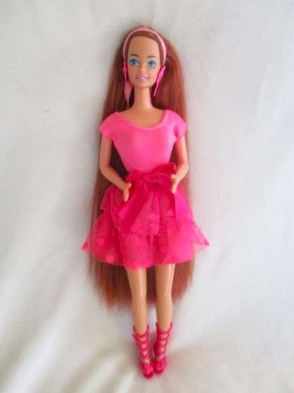 A Mattel Barbie with gorgeous EXTRA long red hair with original earrings - knees bend