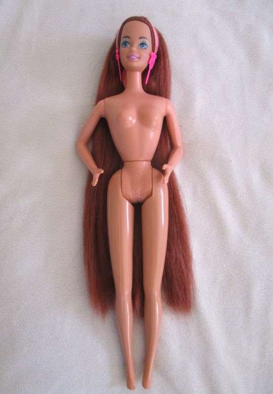 A Mattel Barbie with gorgeous EXTRA long red hair with original earrings - knees bend
