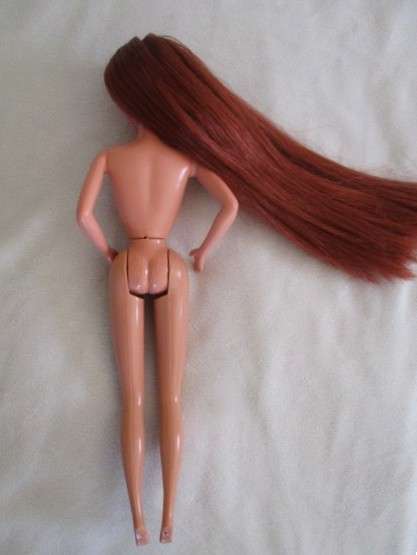 A Mattel Barbie with gorgeous EXTRA long red hair with original earrings - knees bend