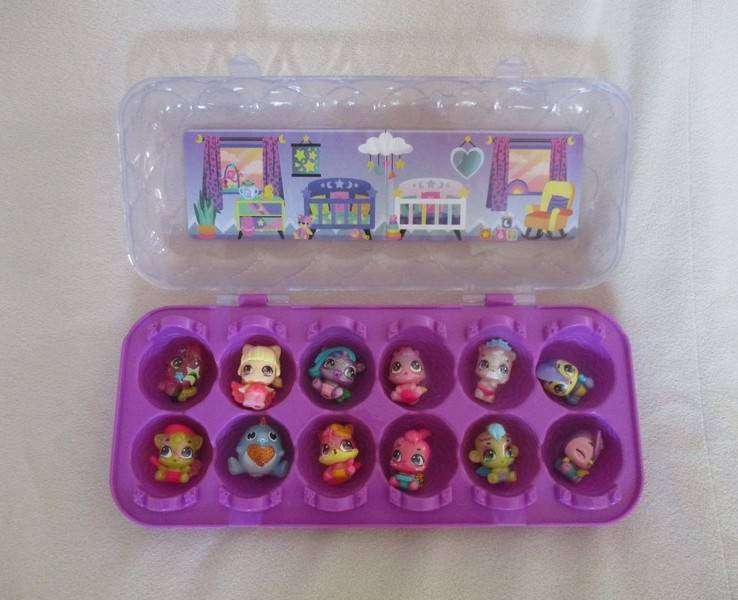A plastic egg carton containing twelve Hatchimals CollEGGtibles