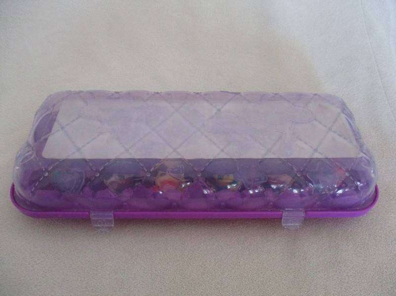 A plastic egg carton containing twelve Hatchimals CollEGGtibles