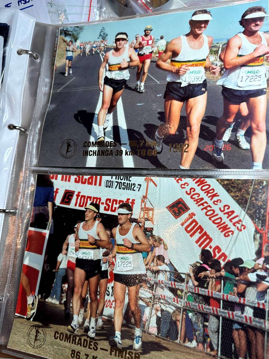 Comrades Marathon Folder with 11 medals, cloth badges etc.
