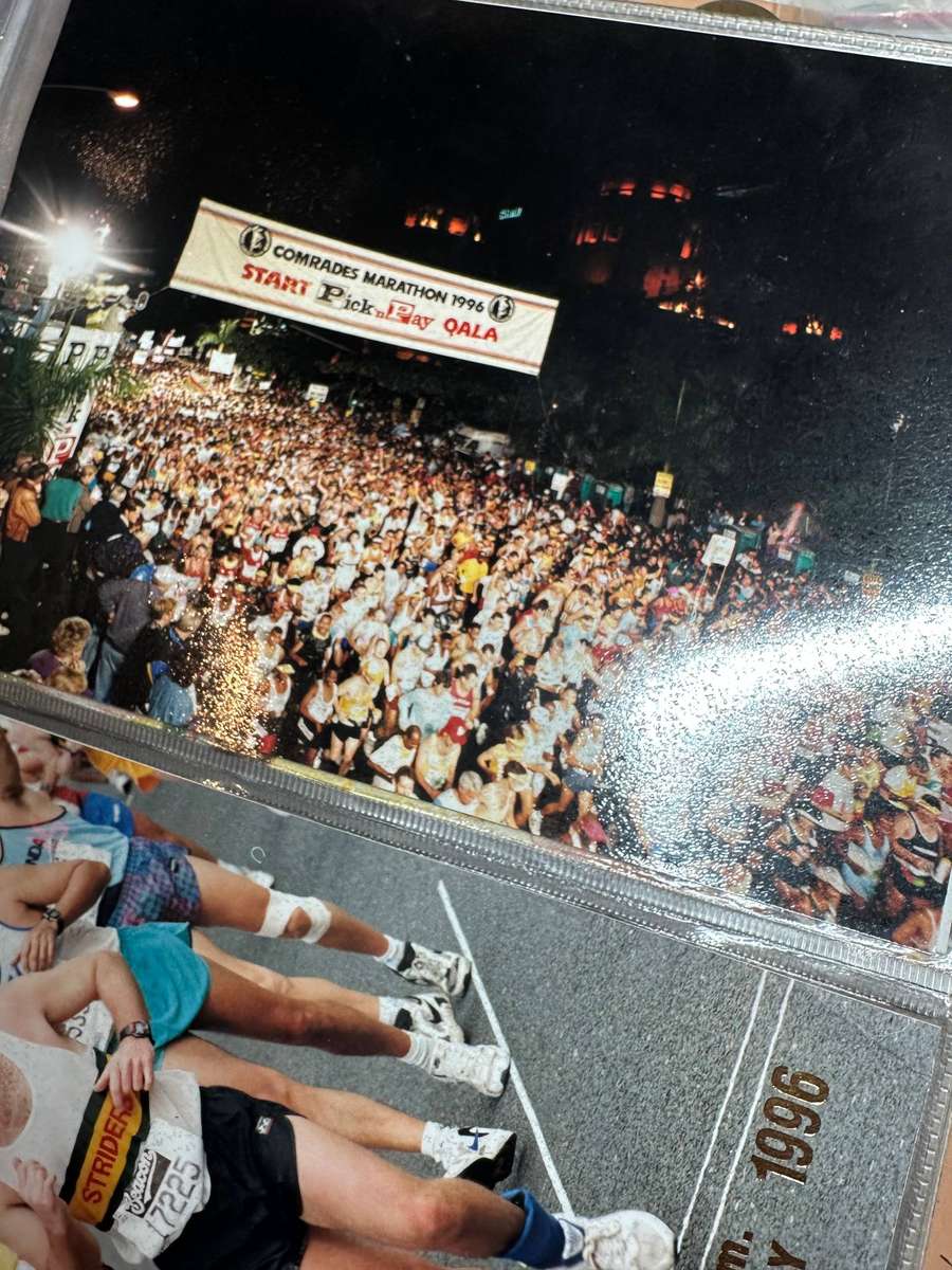 Comrades Marathon Folder with 11 medals, cloth badges etc.