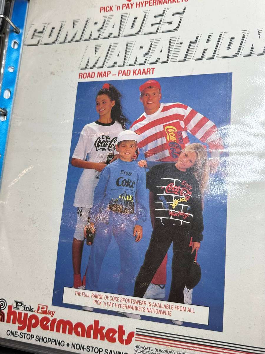 Comrades Marathon Folder with 11 medals, cloth badges etc.