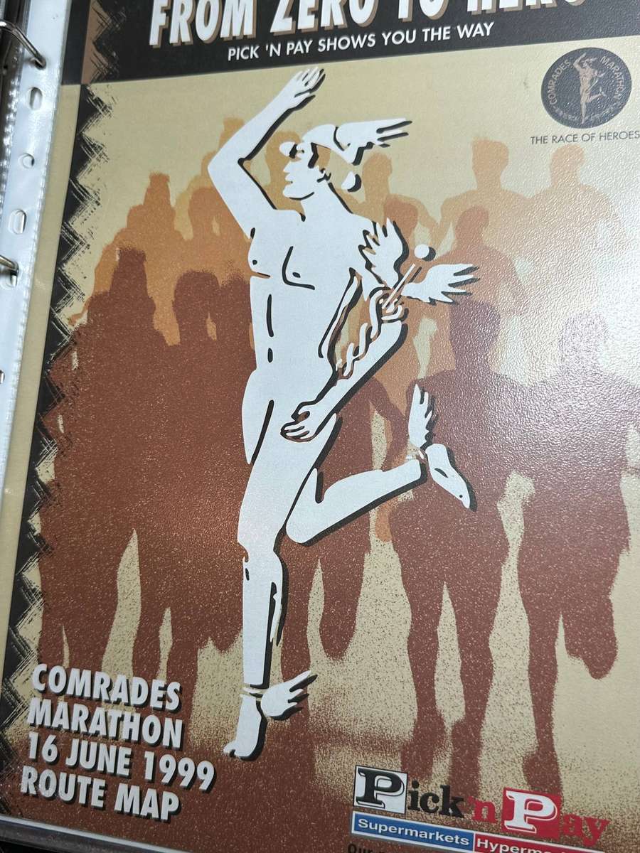 Comrades Marathon Folder with 11 medals, cloth badges etc.