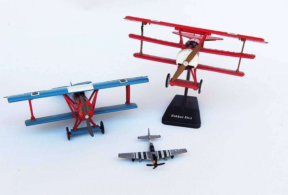 Three airplane models , two hardened plastic models by New Ray and a die cast metal model