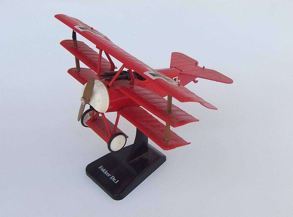Three airplane models , two hardened plastic models by New Ray and a die cast metal model