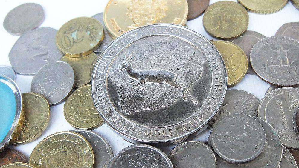 A bunch of medallions , over 100 world coins + 5 Euro note and allot of spare watch parts