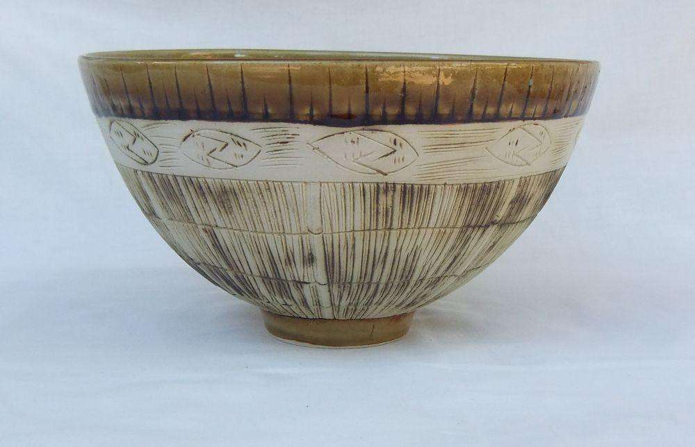 A large vintage hand made pottery fruit bowl with makers mark to base