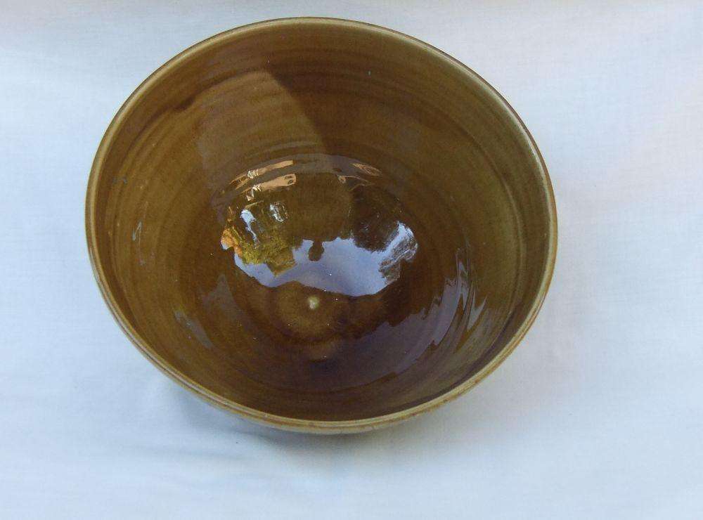 A large vintage hand made pottery fruit bowl with makers mark to base