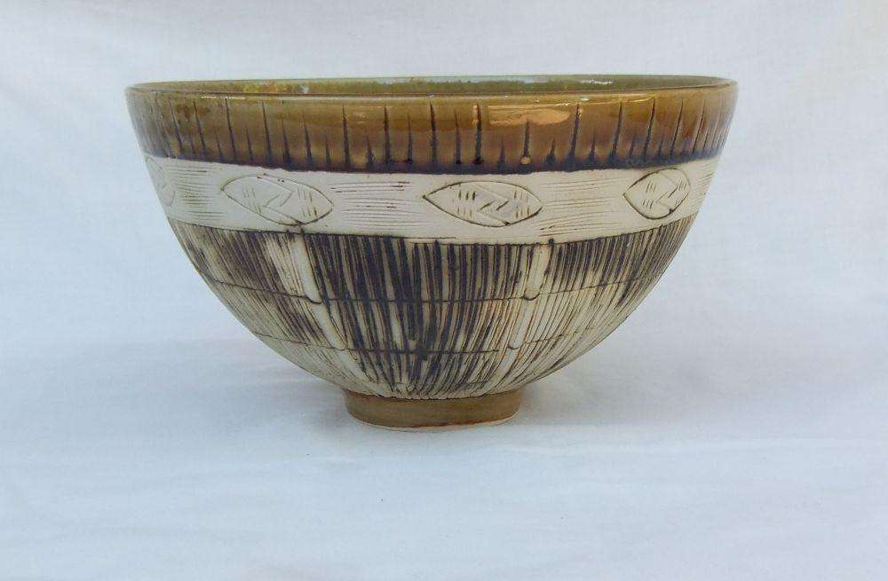 A large vintage hand made pottery fruit bowl with makers mark to base