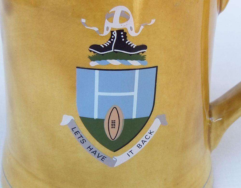 A vintage bar water jug with rugby theme made by Wade England