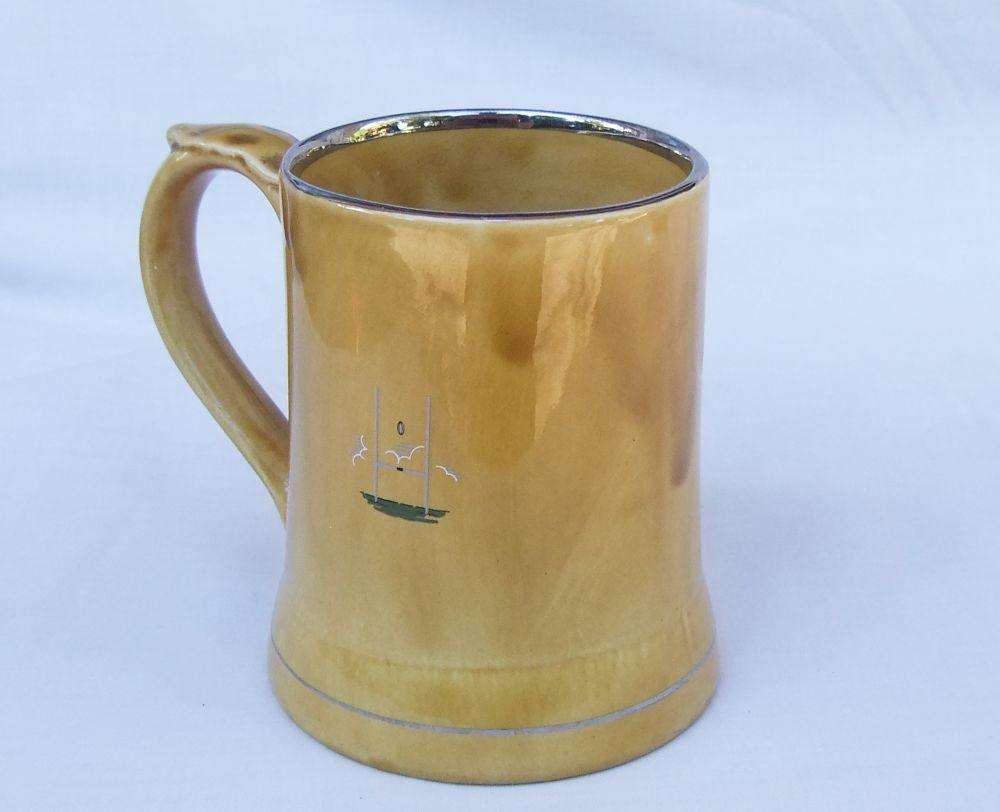 A vintage bar water jug with rugby theme made by Wade England