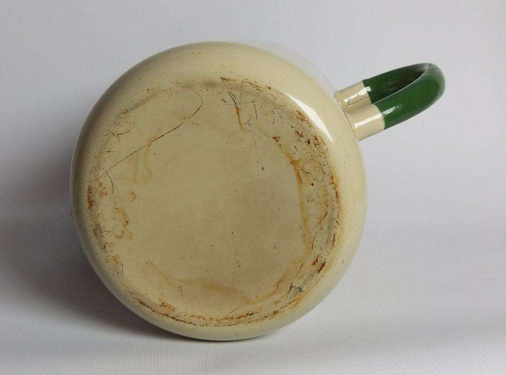 A vintage enamel camping tea or coffee pot