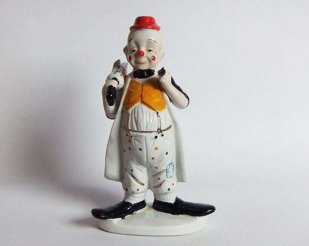 A vintage porcelain cigar smoking clown ornament