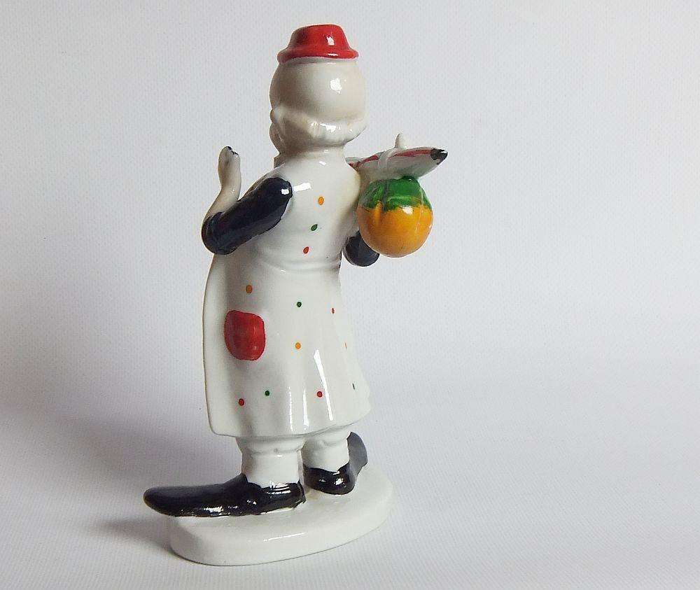 A vintage porcelain cigar smoking clown ornament