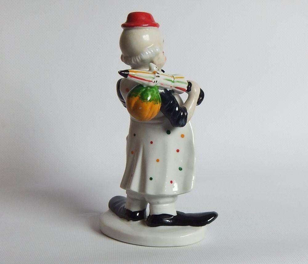A vintage porcelain cigar smoking clown ornament