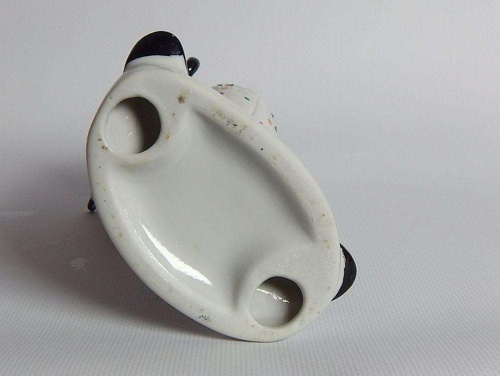 A vintage porcelain cigar smoking clown ornament