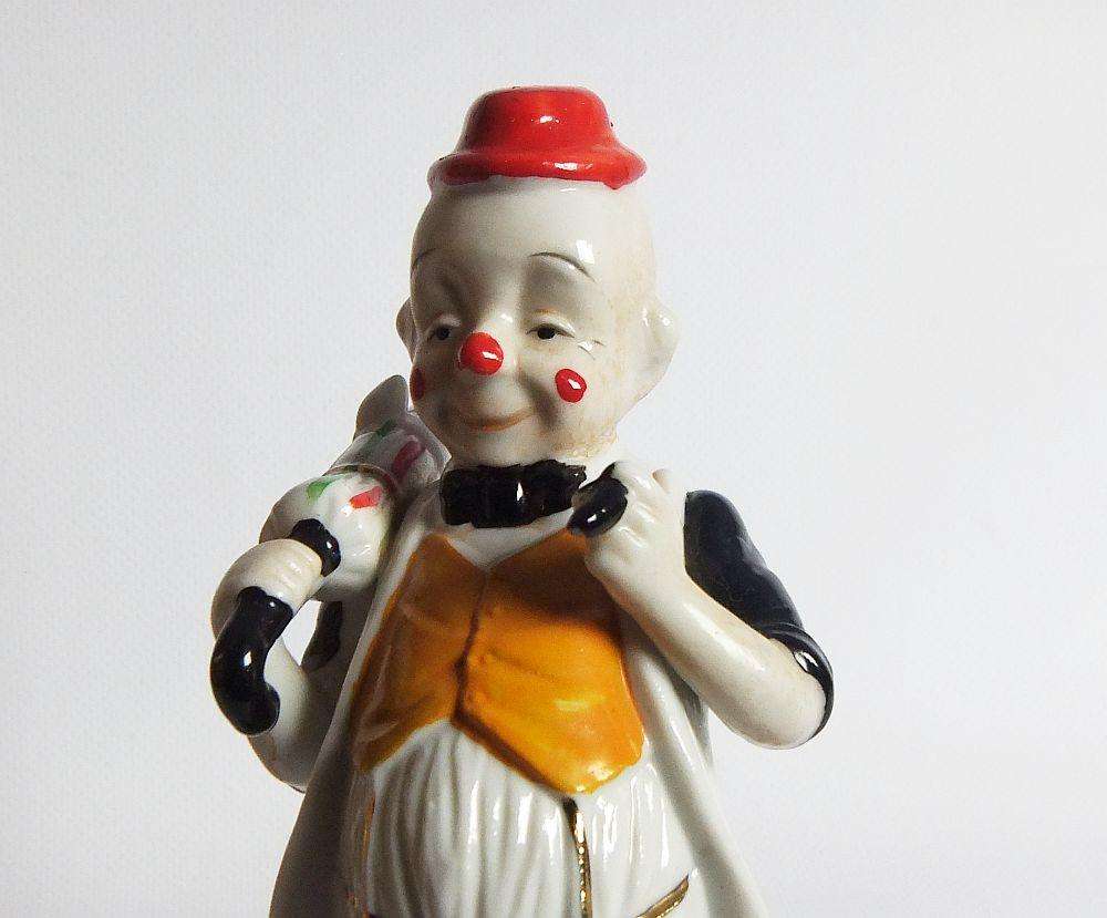 A vintage porcelain cigar smoking clown ornament