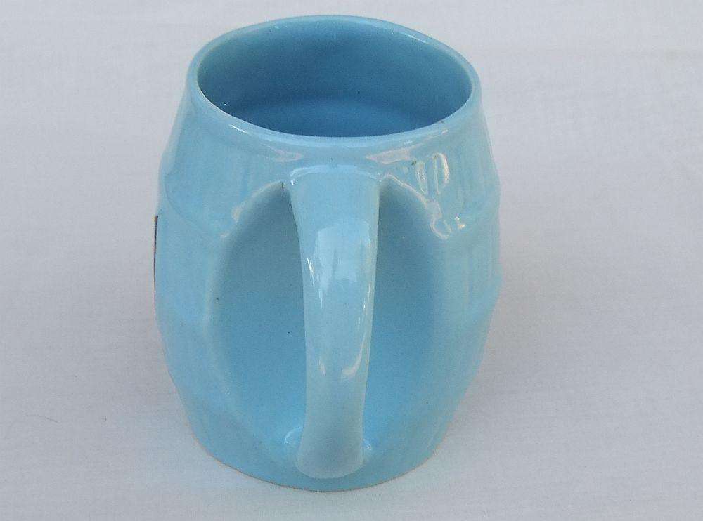 A vintage South African pottery mug with equestrian theme