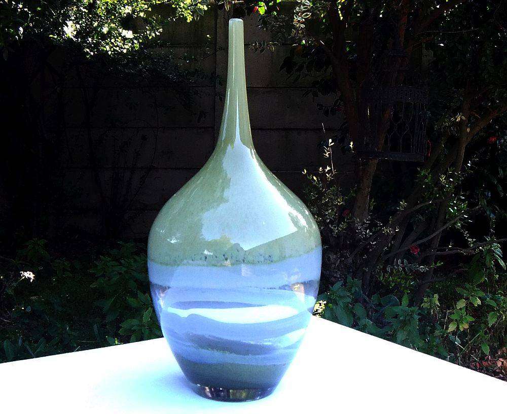 A tall , heavy for size and unique vintage art glass vase with interesting design