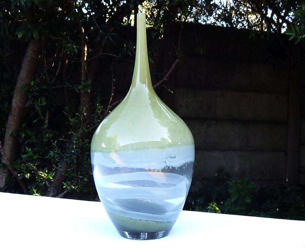 A tall , heavy for size and unique vintage art glass vase with interesting design