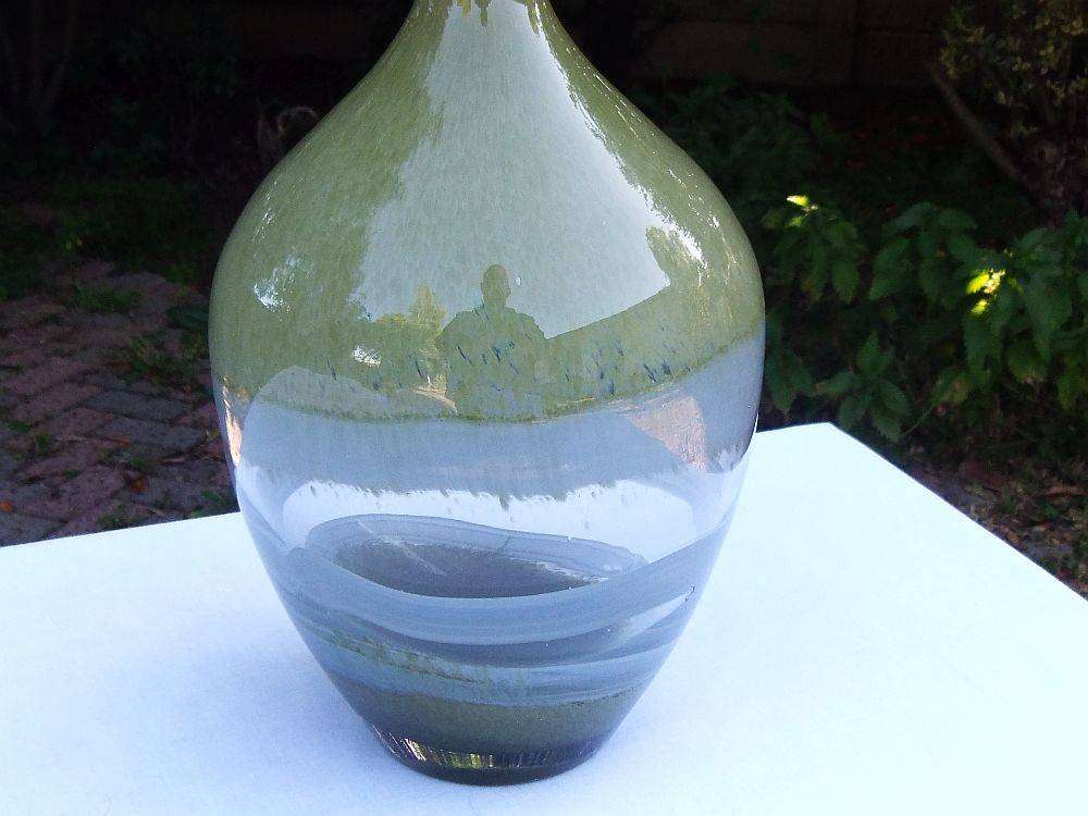 A tall , heavy for size and unique vintage art glass vase with interesting design
