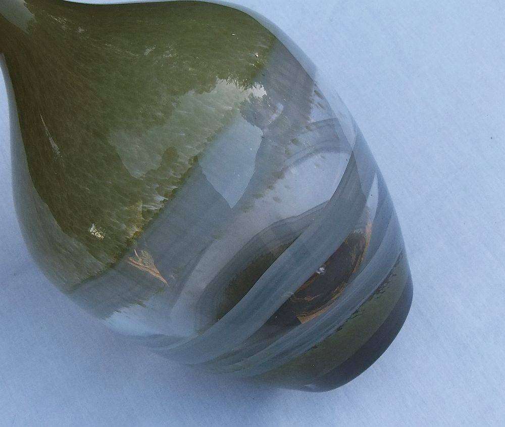 A tall , heavy for size and unique vintage art glass vase with interesting design