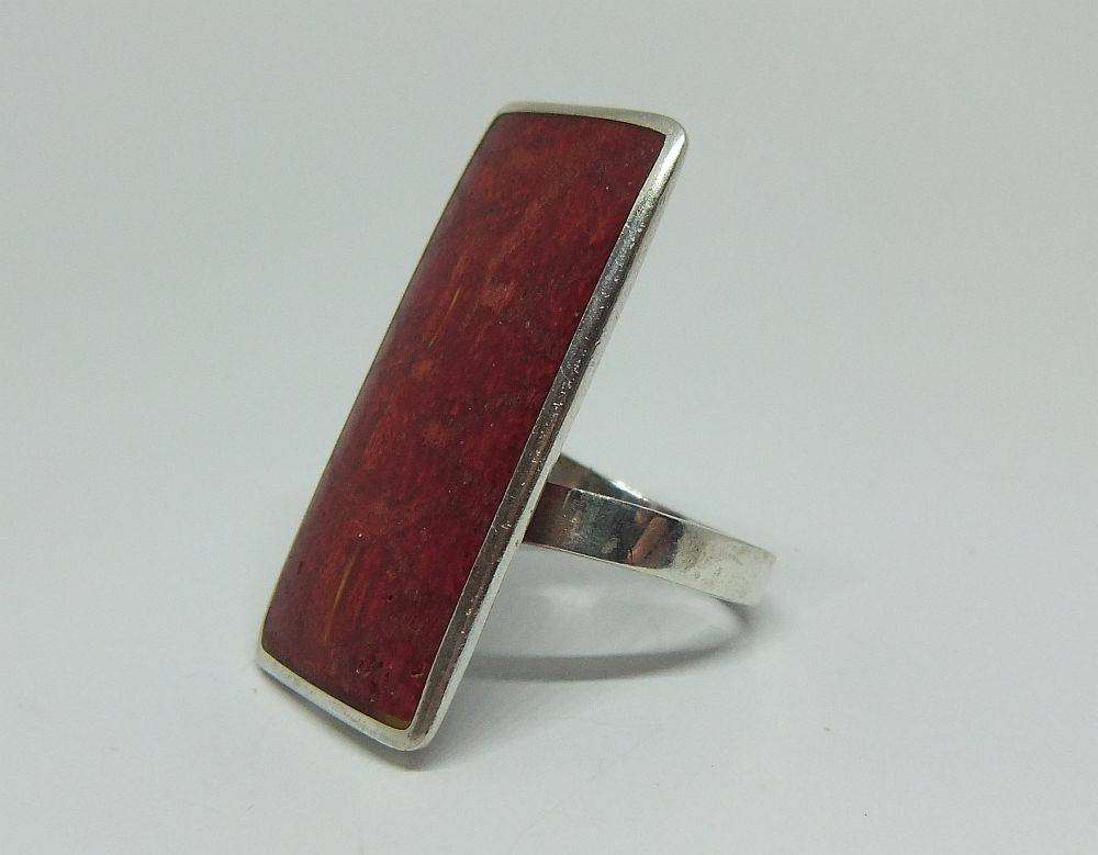 A unique adjustable sterling silver ring set with genuine coral