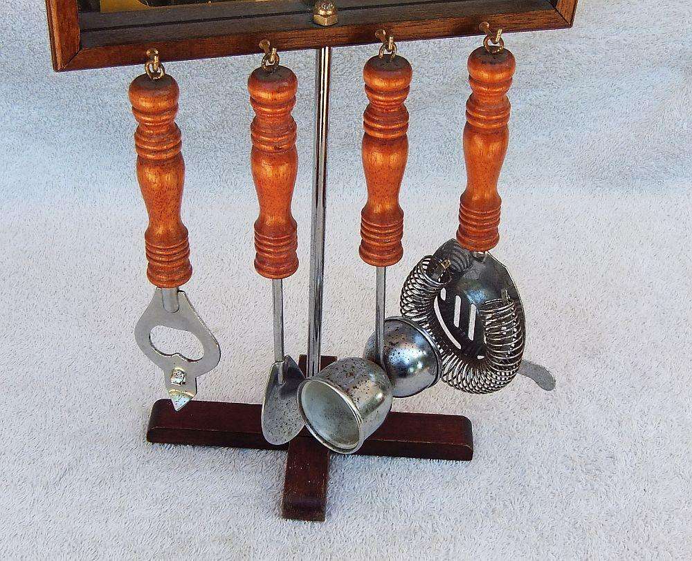 A vintage bar tool stand with mirror and accessories