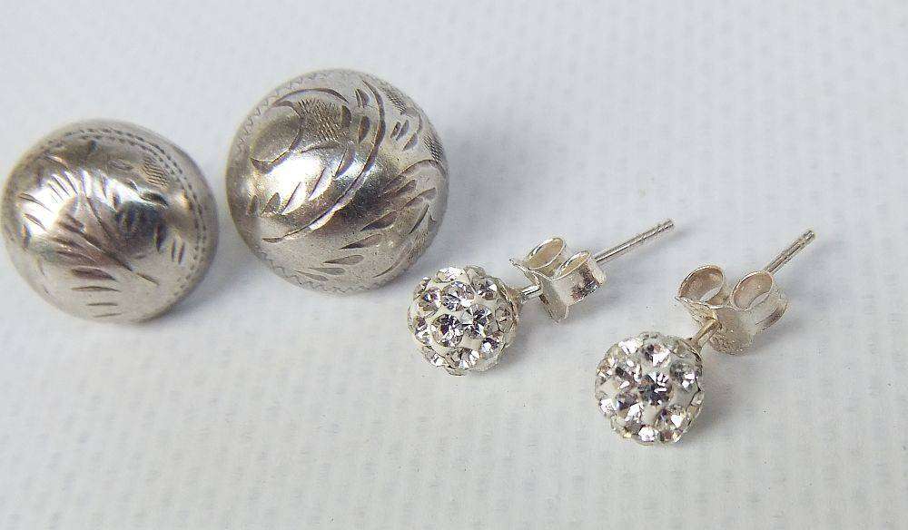 A pair of sterling silver dome earrings and sterling silver studs with faceted insets