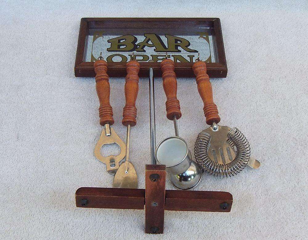 A vintage bar tool stand with mirror and accessories