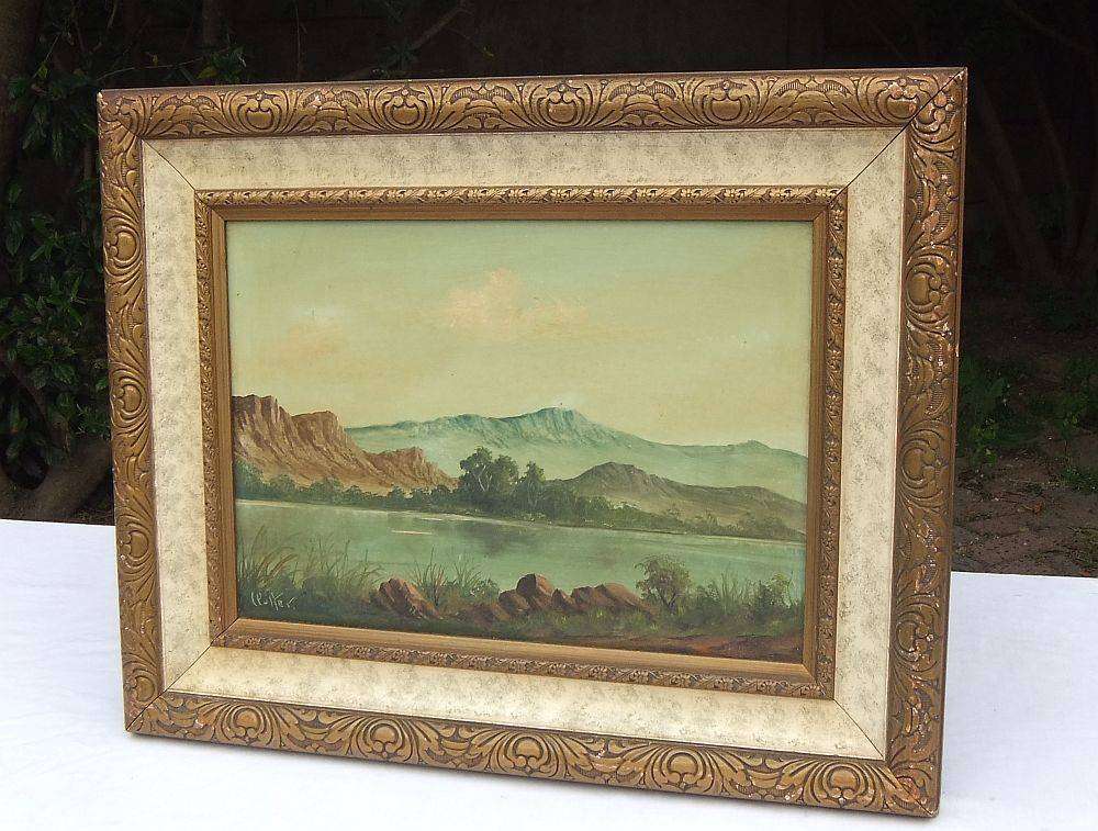An original framed vintage oil painting depicting a lake scene signed by the artist