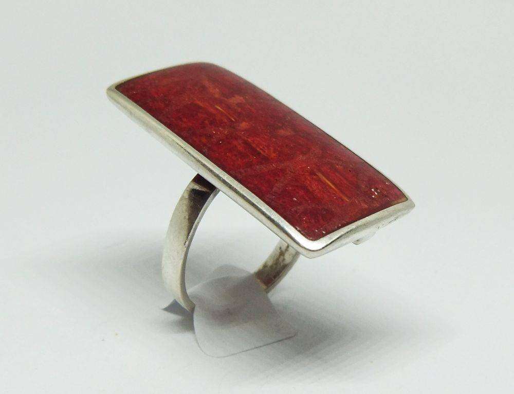 A unique adjustable sterling silver ring set with genuine coral