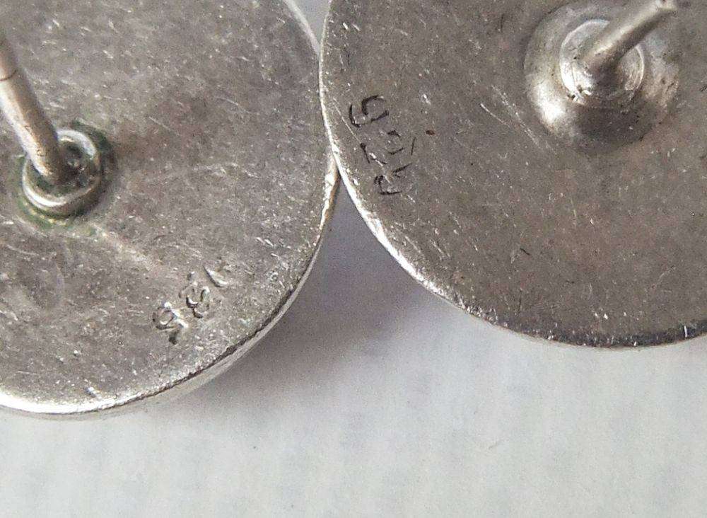 A pair of sterling silver dome earrings and sterling silver studs with faceted insets