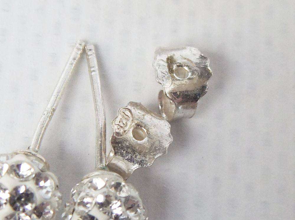 A pair of sterling silver dome earrings and sterling silver studs with faceted insets