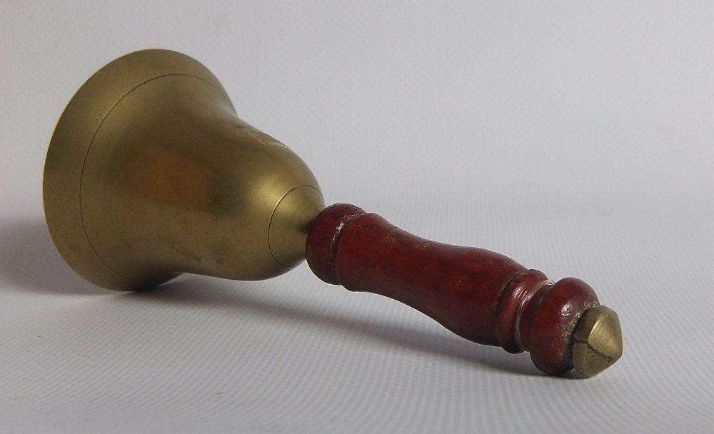 A vintage brass bell with wooden handle and wooden box with brass fittings and inlay