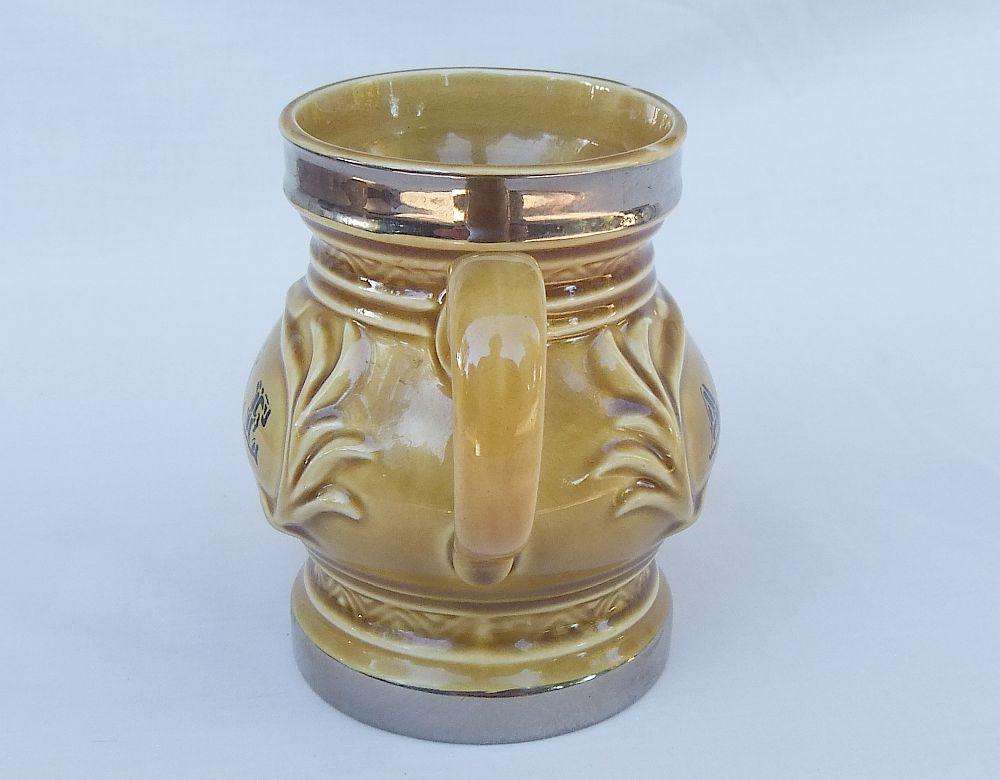 A vintage Wade porcelain jug with ALE motif