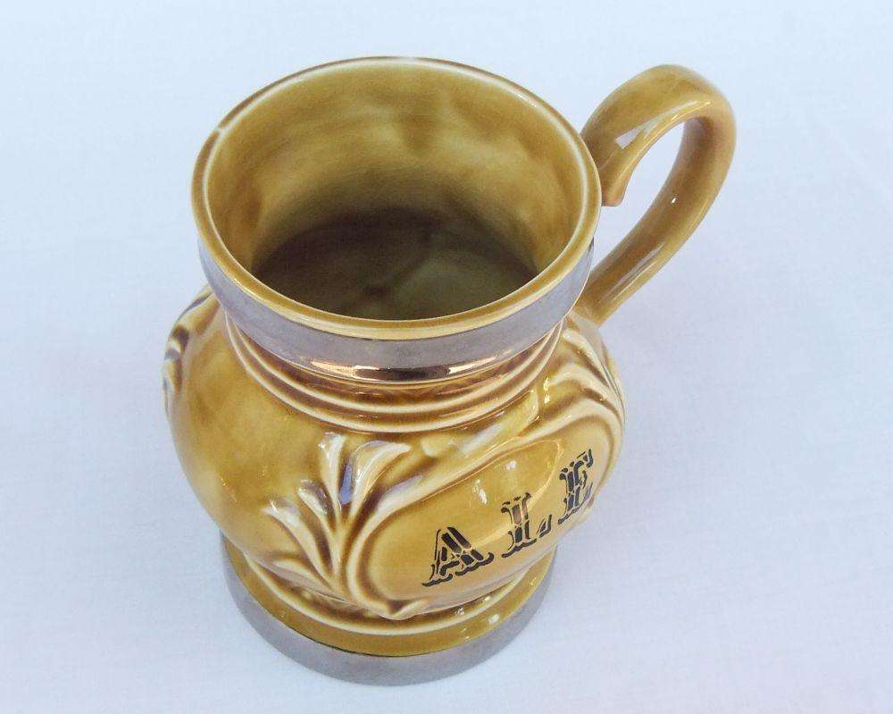 A vintage Wade porcelain jug with ALE motif