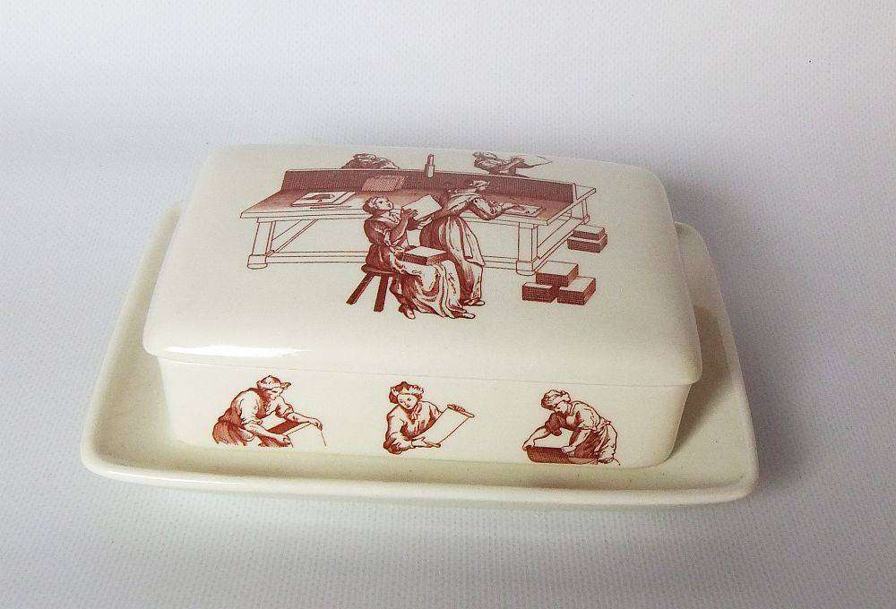 A vintage lidded porcelain cheese or butter dish by Wedgwood England depicting papermakers