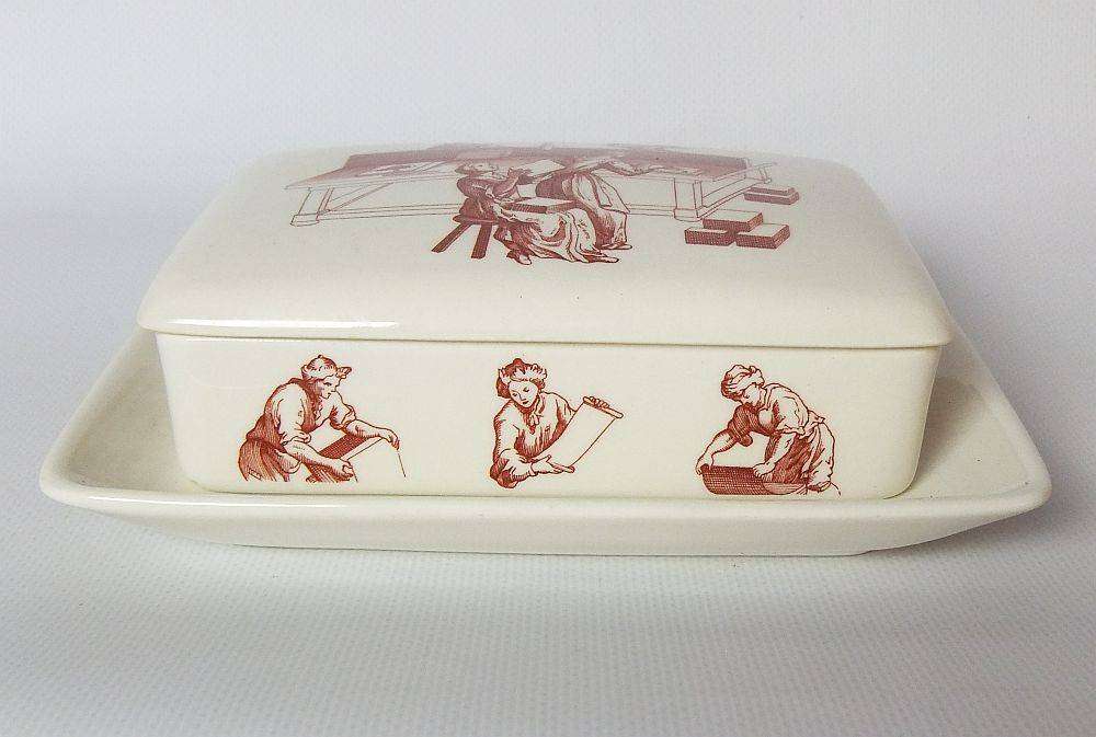 A vintage lidded porcelain cheese or butter dish by Wedgwood England depicting papermakers