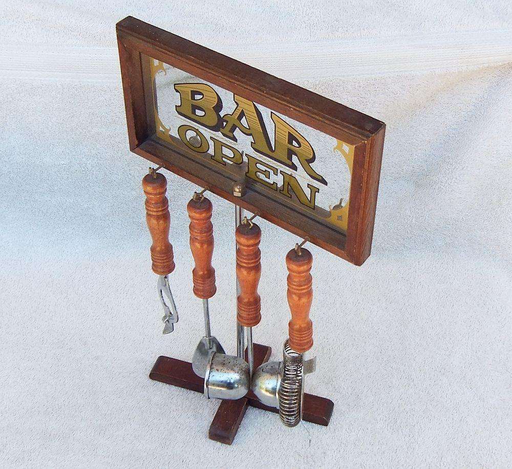 A vintage bar tool stand with mirror and accessories