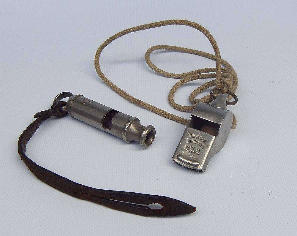 An antique 1917 WW1 whistle and a vintage The Acme Thunderer whistle