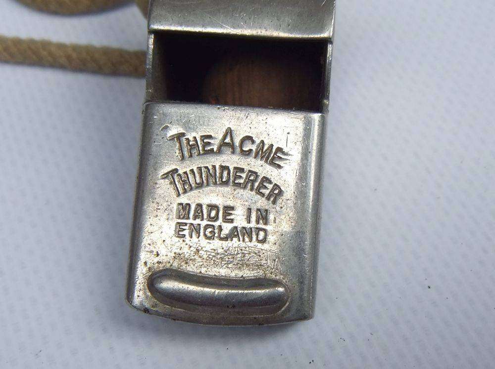 An antique 1917 WW1 whistle and a vintage The Acme Thunderer whistle