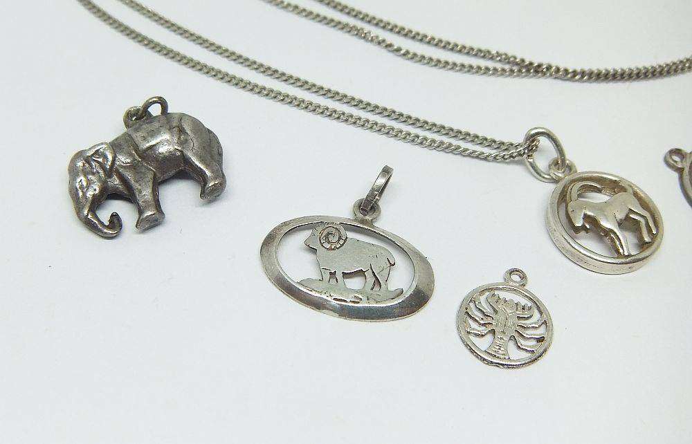 A long sterling silver necklace with a variety of 835 silver and sterling silver pendants or charms